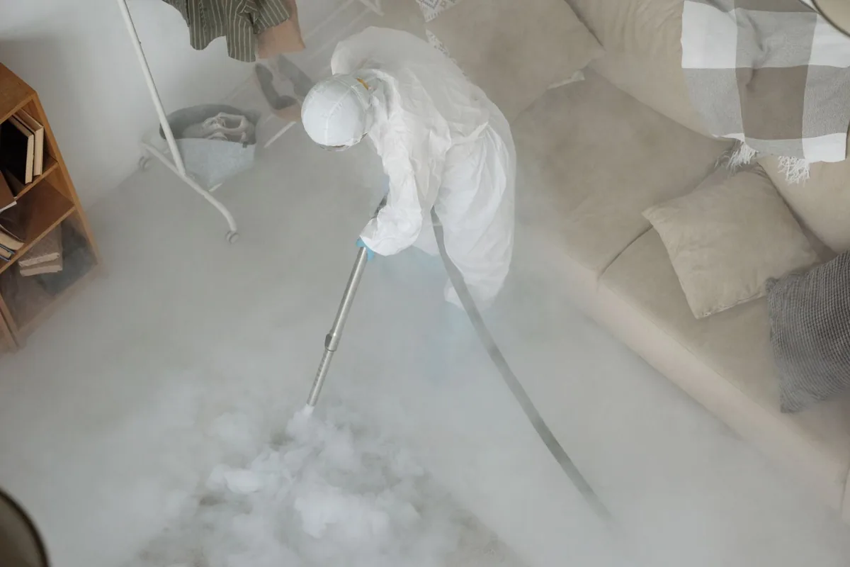 Biohazard cleanup technician in protective equipment, Baxter Springs, KS